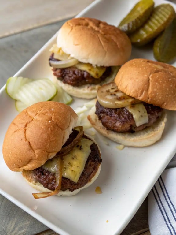 Serving a platter of mini burger sliders A festive platter of mini burger sliders surrounded by fries and dipping sauces