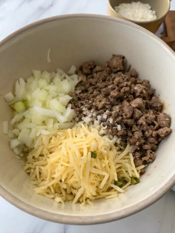 Step 2 for hamburger hashbrown casserole — process in progress