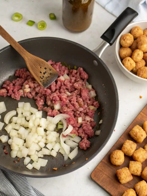 Step 2 for tater tot casserole — process in progress