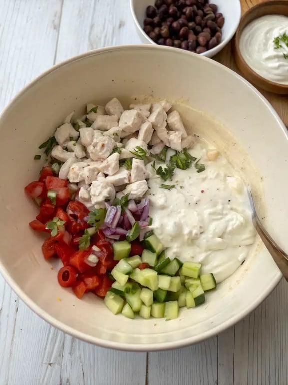 Mediterranean chicken salad — step 4 Step 4 for Mediterranean chicken salad — gently folding ingredients together