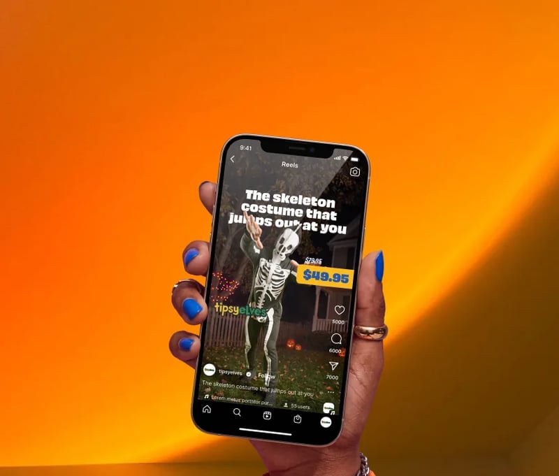 Tipsy Elves skeleton costume video ad on a phone against an orange background