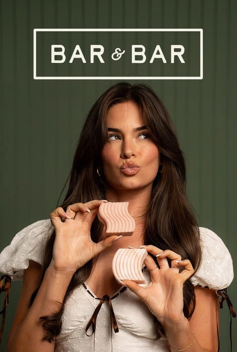 Bar & Bar campaign photo of a model holding pink snack bars
