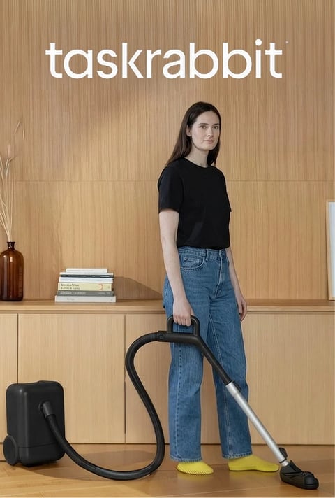 Taskrabbit tasker vacuuming the floor of a bright living room