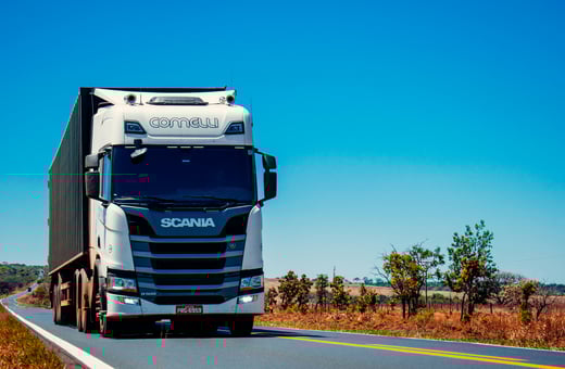 Коммерческий грузовик Scania R-серии на открытой дороге, иллюстрирующий наше стремление поддерживать бесперебойную работу коммерческих автопарков с помощью профессионального ремонта.