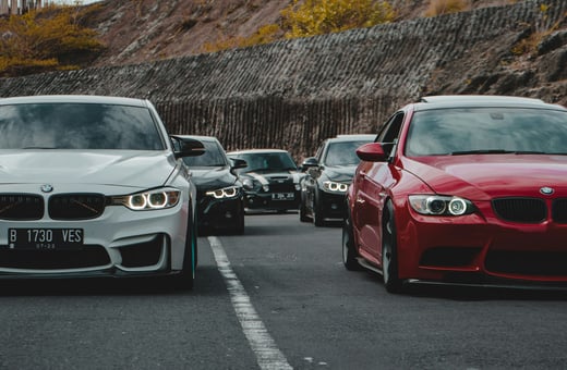 Мощные седаны BMW M3 в белом и красном цветах, демонстрирующие наш опыт в тюнинге и ремонте элитных спортивных автомобилей.