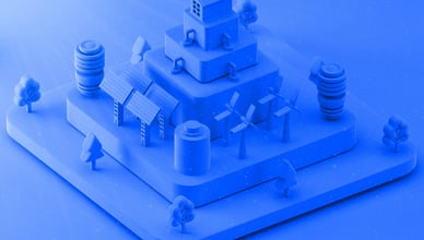 Dva 3D designéři diskutují nad 3D tištěným objektem, zatímco si prohlížejí návrh na tabletu, s 3D tiskárnou v pozadí, což symbolizuje proces DfAM.