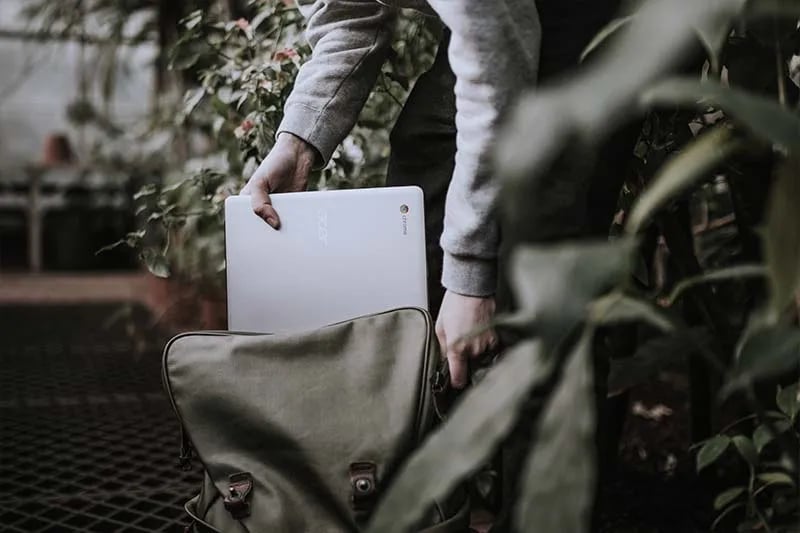 a man packing his laptop