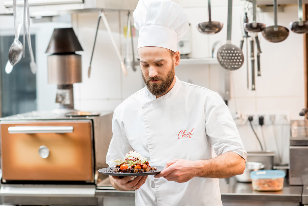 Chef standing with a delicious dish
