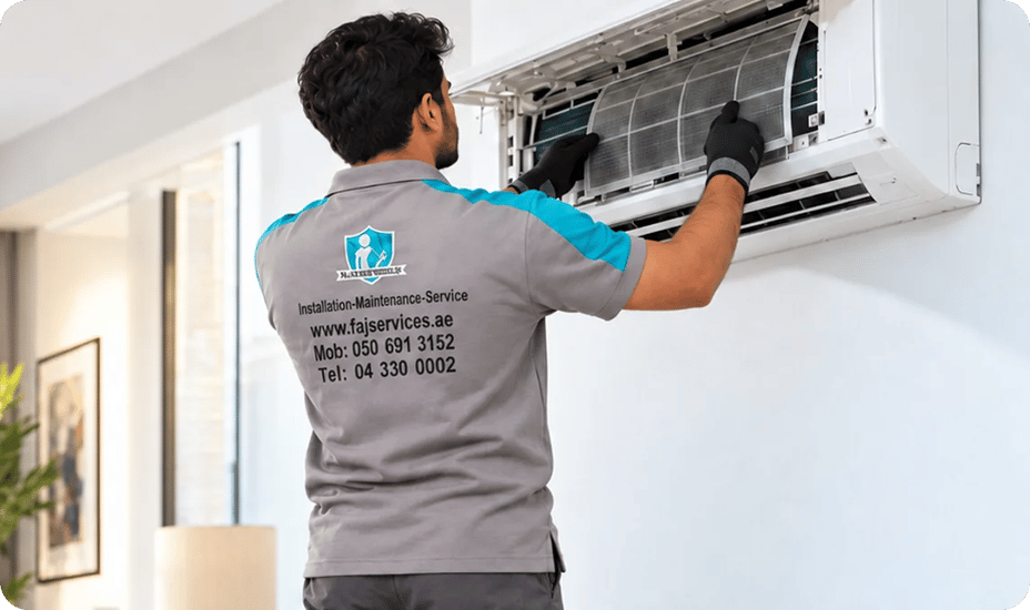 FAJ technician servicing a commercial cassette air conditioner in Dubai