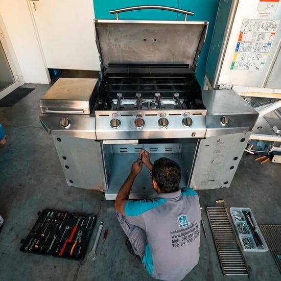 FAJ technician servicing a barbecue grill in Dubai