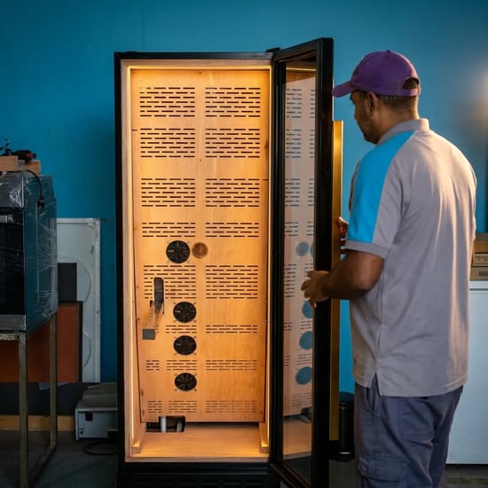 FAJ technician inspecting an electric cigar humidor cabinet in Dubai
