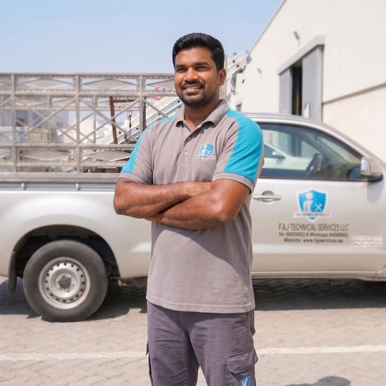 FAJ Technical Services technician beside a service vehicle