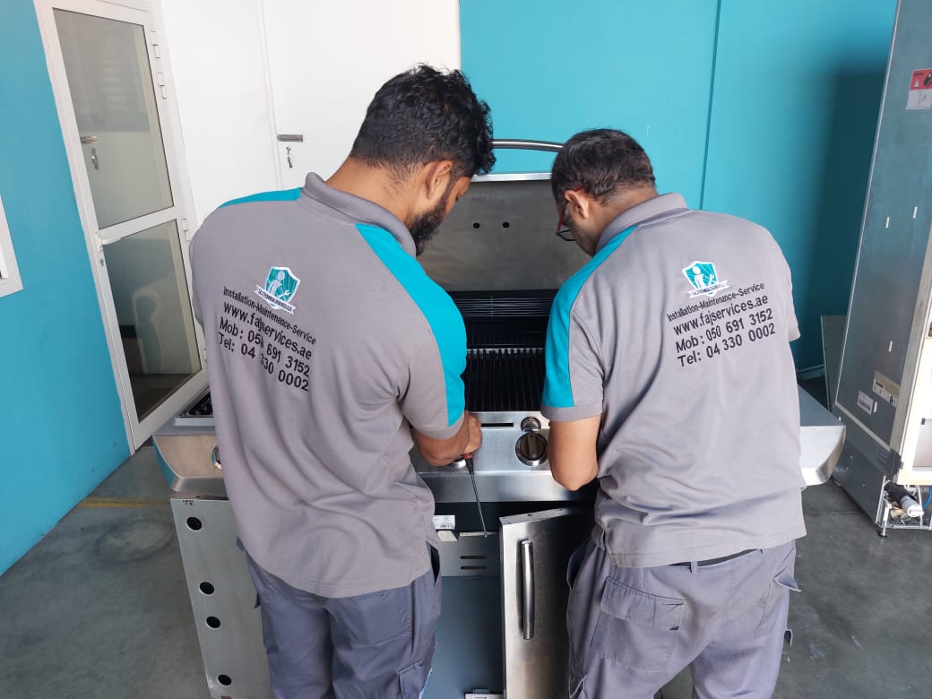FAJ technician servicing a barbecue grill in Dubai