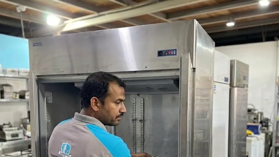 FAJ technician inspecting a commercial refrigeration system