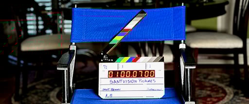 Director in edit bay reviewing a scene with headphones