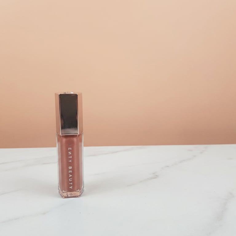 Generate a single image that presents the same lipstick in multiple angles within a clean ecommerce layout, including one main front view (center, largest), one side view (showing the profile, depth, and structural details), and one three-quarter perspective view (slightly rotated to show overall shape and texture). Arrange all views in a clean, balanced horizontal layout where the front view is the most prominent and secondary views are smaller and aligned neatly. All views must represent the exact same product with the same shape, color, and details — no variation in design or style between views. Use a clean light pink or neutral background with soft studio lighting, high clarity and realistic material rendering, and a professional ecommerce product photography style.