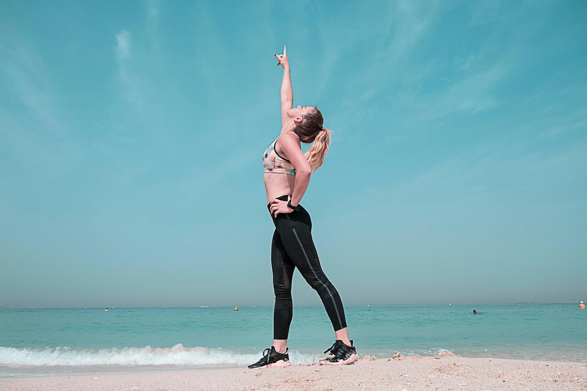 anime tattoo before photo - woman doing the yoga on the beach