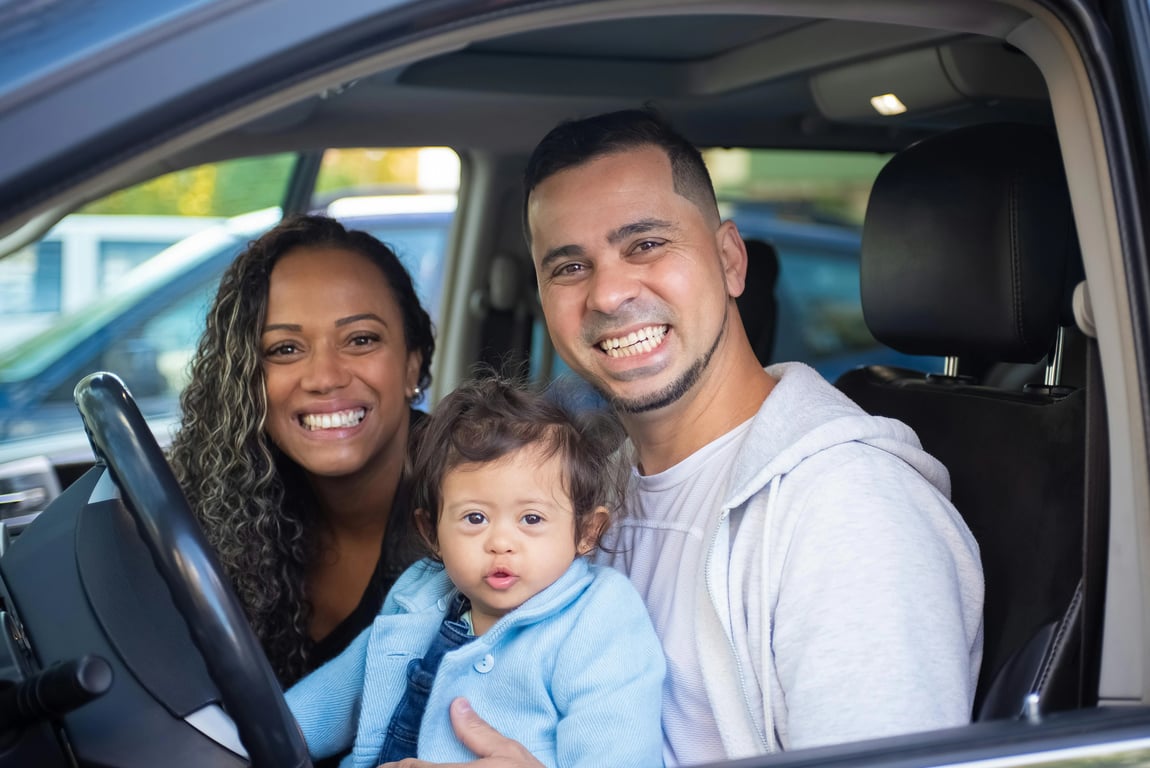 a portrait of a family transformed into a travel-themed family portrait, all members wearing coordinated casual travel outfits with backpacks or hats, placed in a scenic travel environment such as a city street or countryside, using dynamic standing or walking poses and curious engaged expressions