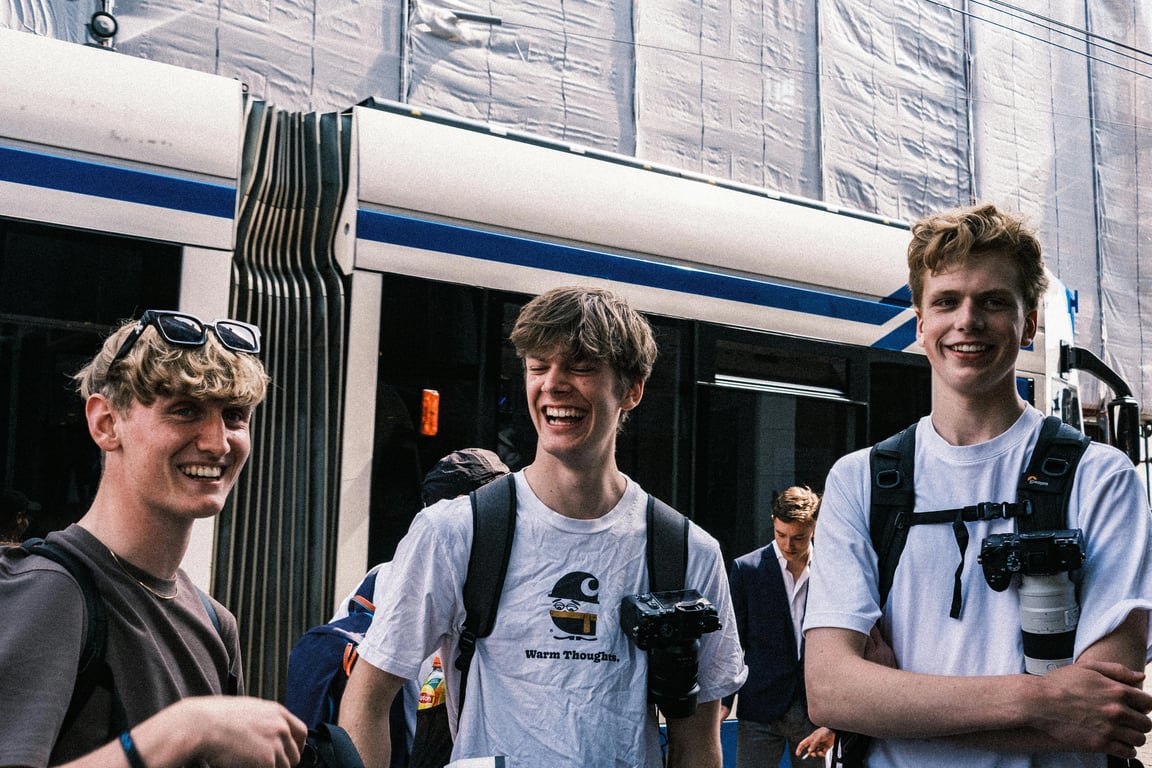 a portrait of a male group styled in modern K-pop boy group outfits, featuring refined tailoring, coordinated silhouettes, clear outfit structure, composed posture, and minimal studio background