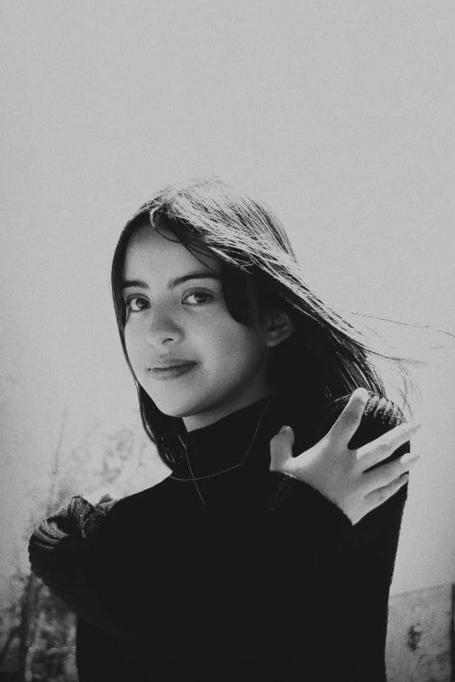 a portrait of a person transformed with dramatic anime visuals inspired by Demon Slayer, including dynamic lighting, bold ink lines, and cinematic depth