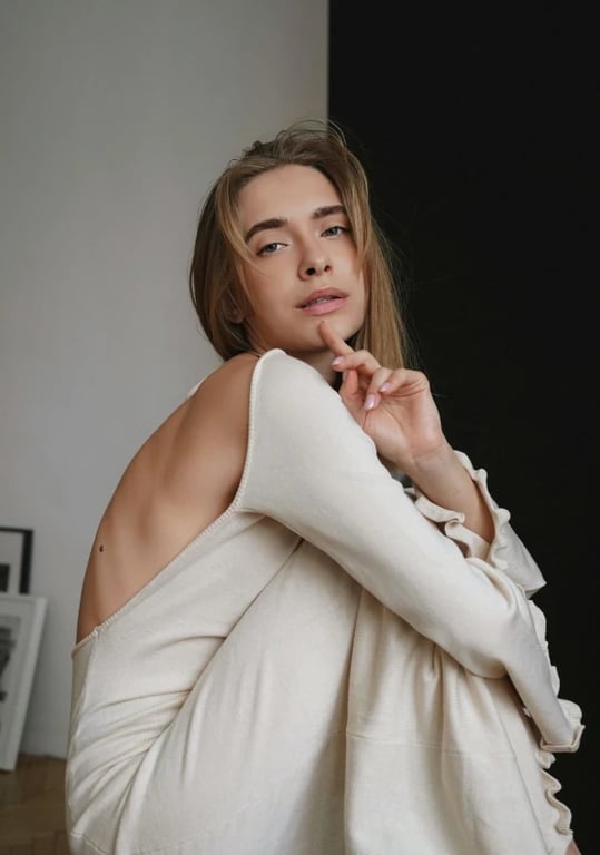 a portrait of a person styled in a Korean daily outfit look, soft neutral and pastel tones, light layering clothing, relaxed silhouette, natural facial expression, casual upright posture, even soft lighting, and a clean urban-style background