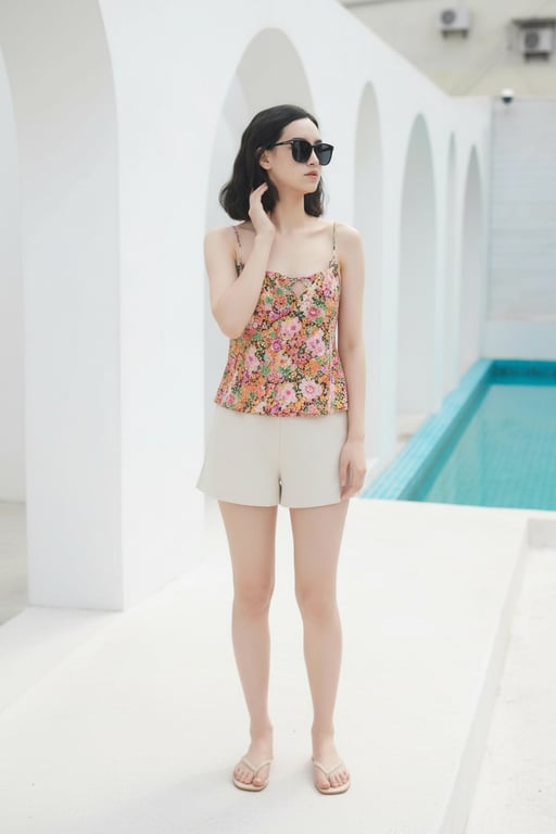 Complete the person’s full body by extending downward from the original image, maintaining the existing fashion style, clothing design, and visual tone. Preserve the original silhouette and posture logic, and reconstruct the lower body with confident stance, realistic proportions, and seamless continuity without changing the background or outfit.