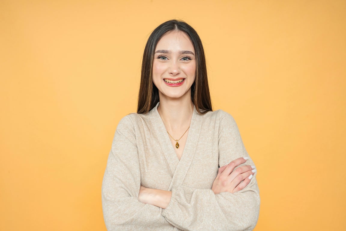 a portrait of a person reimagined in a My Hero Academia–inspired anime art style, with strong clean linework, expressive large anime-style eyes, simplified yet recognizable facial features that preserve identity, and a heroic youthful appearance; apply cel-shaded coloring with clear light and shadow separation; lighting should be dramatic and directional, simulating anime key light from above or side with strong highlights and defined shadows; color palette vibrant but controlled, avoiding over-saturation; background simplified into anime-style gradient or abstract action backdrop; composition half-body or head-and-shoulders, slightly dynamic pose if possible; clothing redesigned into anime-style hero outfit or school-uniform-inspired costume with clear shapes and bold color blocks; final result should resemble a polished My Hero Academia character illustration, not a generic anime filter