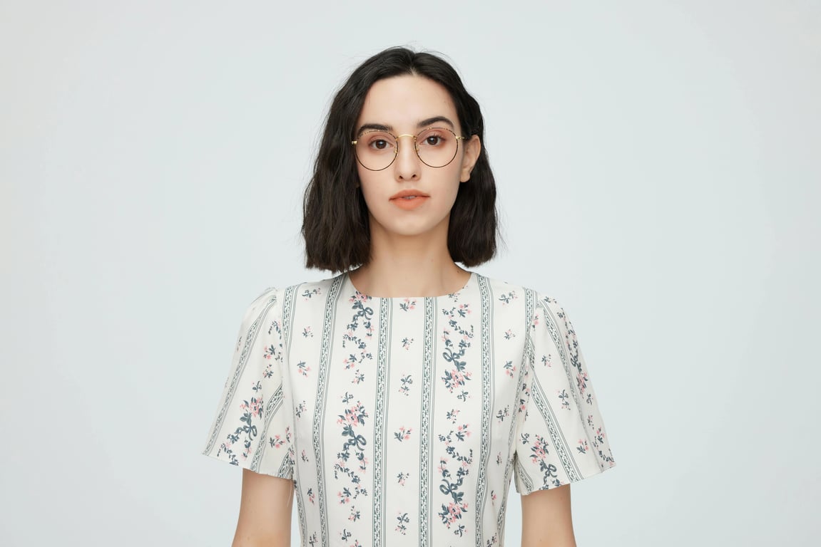 A photo of a girl wearing a plain white dress or light colored outfit.