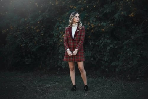 Christmas outfit after – person wearing a tartan skirt set with holiday accessories