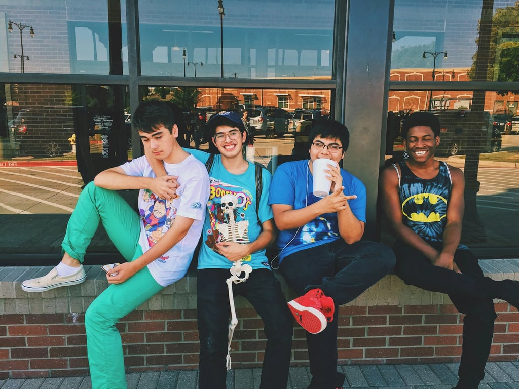a portrait of several men styled in casual K-pop boy group outfits, featuring slim silhouettes, layered tops, light jackets, cohesive color tones, relaxed confident posture, and soft even lighting