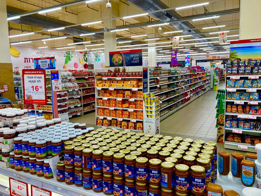 A photo of a realistic plastic bag floating in a supermarket aisle, with a deep-fried filter and the words \"new lore just dropped\" in bold font.