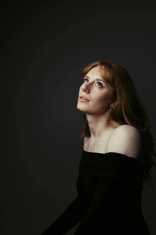 a portrait of a person wearing classic business attire, photographed in a studio-like environment with neutral backdrop, even facial illumination, realistic texture preservation, restrained color grading, and a composed corporate headshot aesthetic