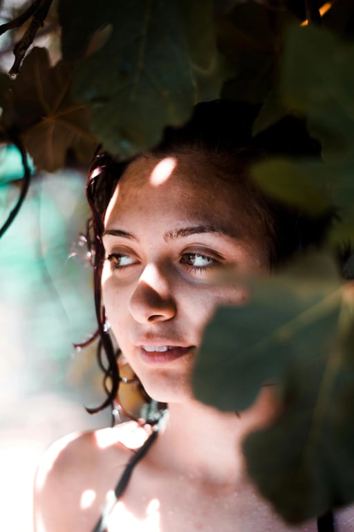 a portrait of a person refined by selectively cleaning chaotic light artifacts, keeping soft face light intact and restoring clear, readable facial detail