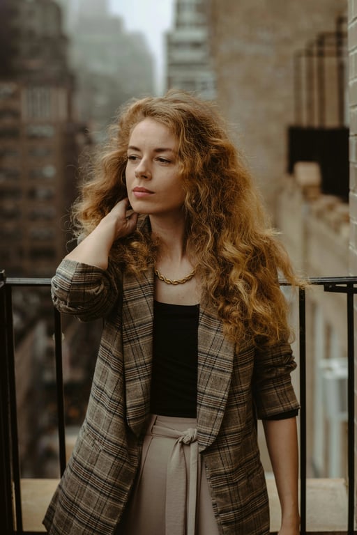 a portrait of a person edited to sit comfortably with one leg crossed over the other, upper body relaxed, shoulders dropped, chest open, neck uncompressed; avoid exaggerated posing; preserve anatomy and clothing folds; background unchanged; result should look naturally composed