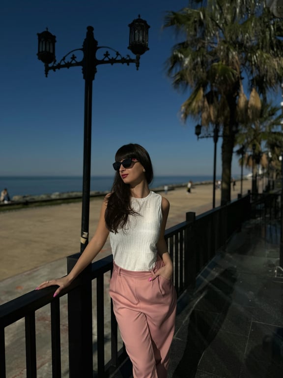 A polished AI studio portrait of a woman, clamshell lighting effect, flawless yet realistic skin, subtle jewelry highlights, professional backdrop, ready for official use.