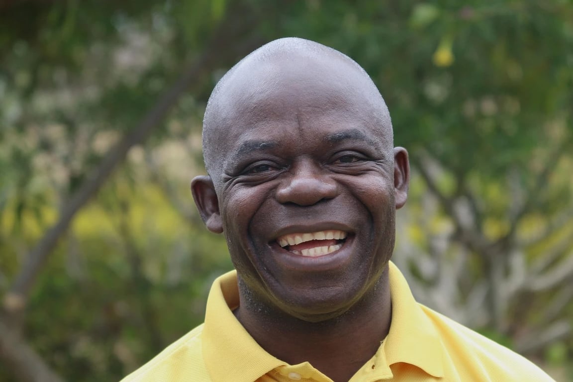 AI teeth whitening filter before photo - bald man smiling in nature