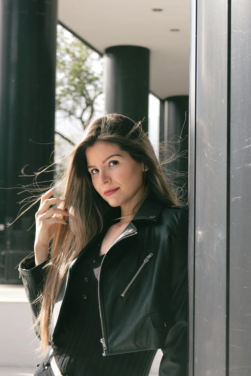 a portrait of a person edited in a Demon Slayer–style anime look, featuring stylized linework, expressive eyes, flowing clothing shapes, dramatic contrast lighting, and a dark atmospheric background