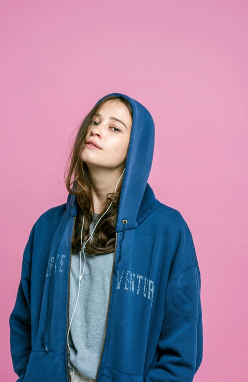 a portrait of a person illustrated as a playful cartoon character with exaggerated eyes or mouth, rounded facial shapes, smooth linework, bright flat colors, and a lighthearted animated personality