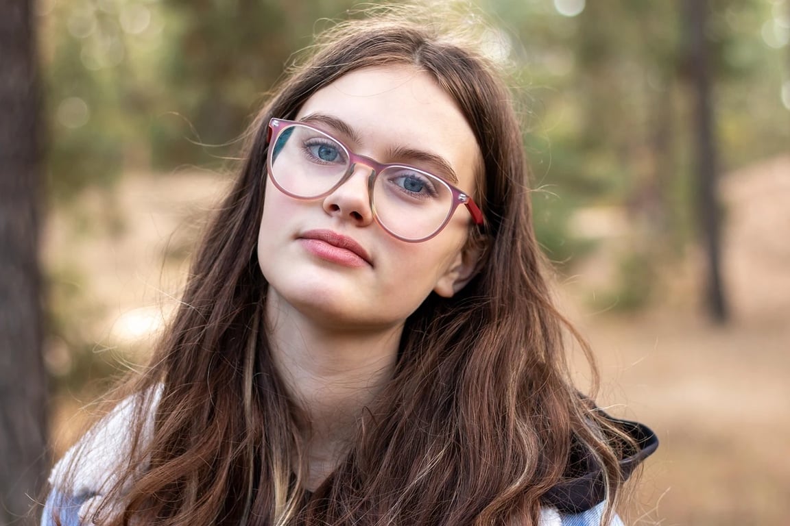 ai remove glasses from photo before photo - woman wearing glasses with red frame