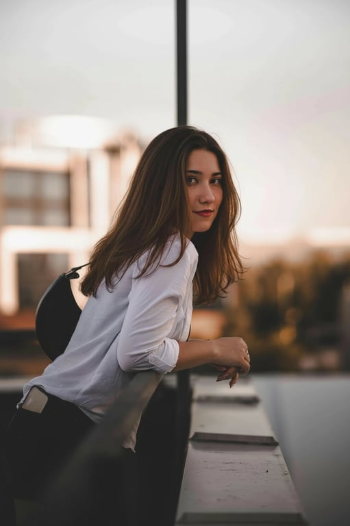 a portrait of a person with increased hair fullness achieved by lifting roots and reinforcing strand density along existing layers; keep original haircut, hairline, and proportions unchanged; avoid helmet-like silhouettes; preserve flyaways and fine strands; no changes to face, posture, or background; result should resemble naturally dense hair