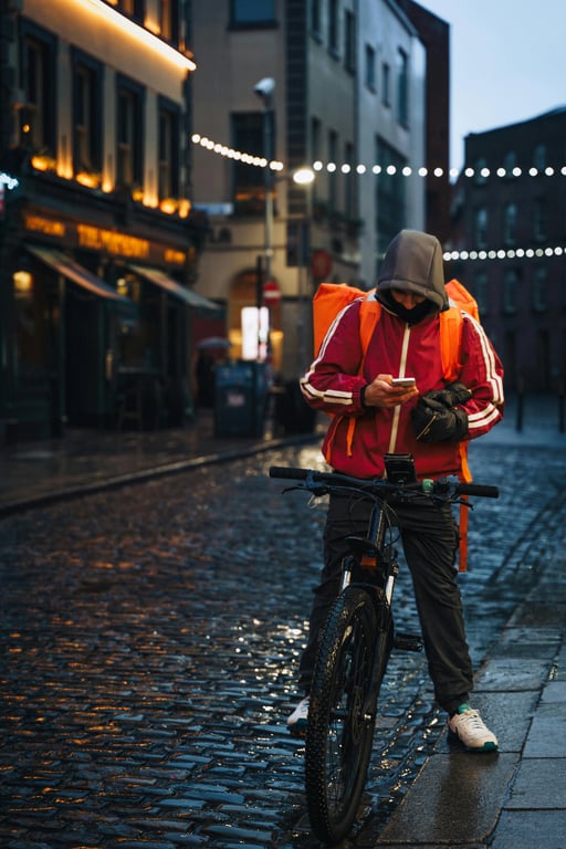 A sci-fi character portrait of a man with cybernetic implants on his face and neck, glowing blue circuitry, in a neon-lit rainy city alley, futuristic and gritty.