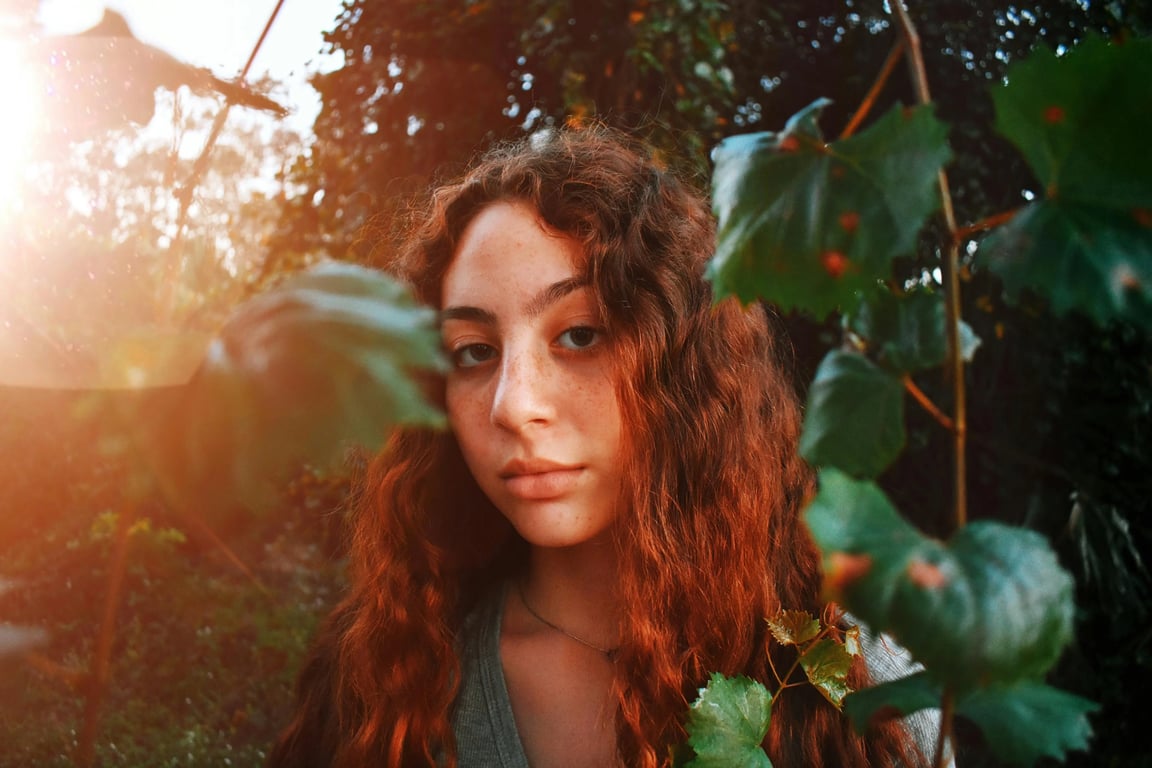 a portrait of a person with natural face lighting preserved, while messy lens flare, glare spots, and uneven shadow artifacts are carefully removed for a clean and clear look