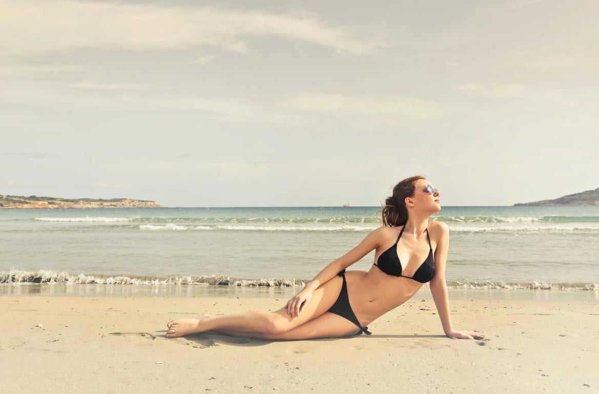 a portrait of a person edited to display a new bathing suit style, focusing on realistic fit, smooth seams, clear garment structure, neutral pose, and uncluttered background