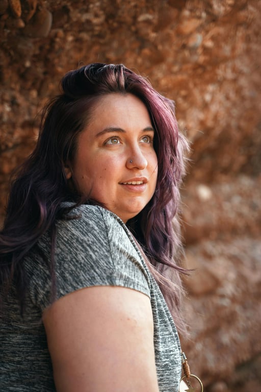 a portrait of a person edited to eliminate visible double chin by reshaping the submental area, tightening loose under-chin contours, and restoring a sharp jaw-to-neck break; maintain chin length and jaw width consistency; preserve realistic skin texture; avoid blur-based tricks; keep original background unchanged; the slimming effect must be strong but natural