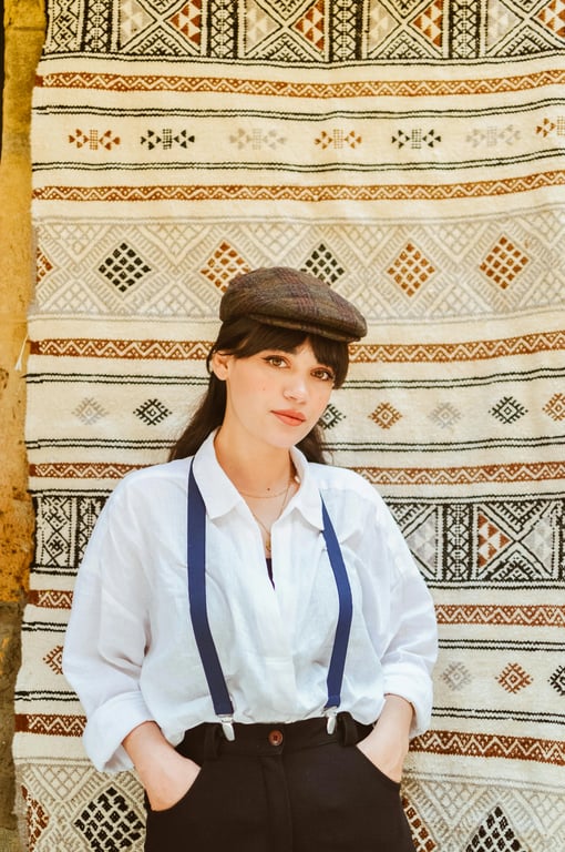 a portrait of a person enhanced with Attack on Titan–style visuals, including sharp line precision, realistic skin shading, subdued color tones, heavy shadows, and a bleak cinematic atmosphere