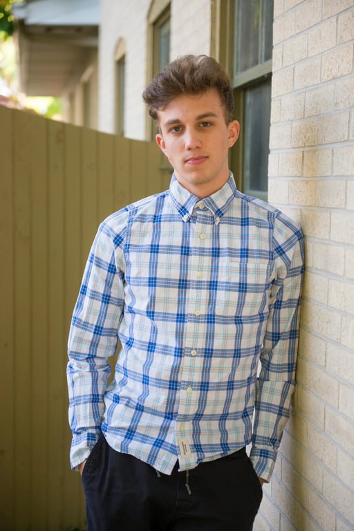 a portrait of a person enhanced with extreme fashion styling, neutral tones, smooth lighting, composed posture, and slightly detailed modern background
