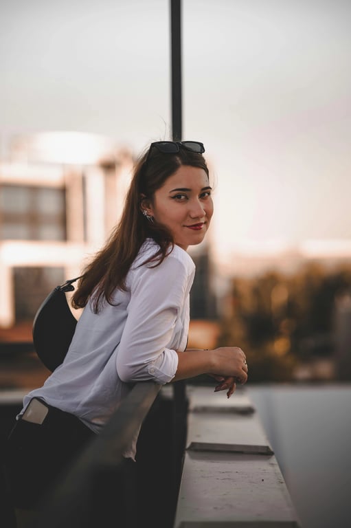 a portrait of a person with increased hair fullness achieved by lifting roots and reinforcing strand density along existing layers; keep original haircut, hairline, and proportions unchanged; avoid helmet-like silhouettes; preserve flyaways and fine strands; no changes to face, posture, or background; result should resemble naturally dense hair