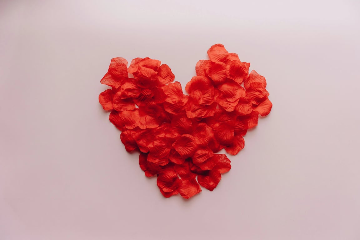 A heart symbol created using only forward and backward slashes and parentheses, forming a clean outline on a dark background.