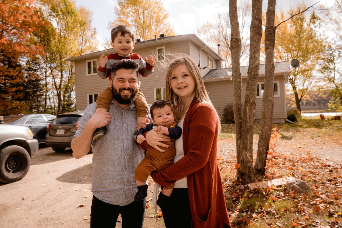 a portrait of a family transformed into a cozy home lifestyle family portrait, all members dressed in comfortable indoor clothing such as sweaters or pajamas, placed in a warm home interior with soft natural light, close relaxed poses, gentle interaction, and an intimate emotionally connected mood