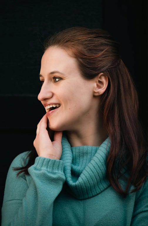 a portrait of a person with the hairline shifted noticeably downward, reducing a high or wide forehead and making the overall face appear smaller and more balanced with fuller hair framing the face
